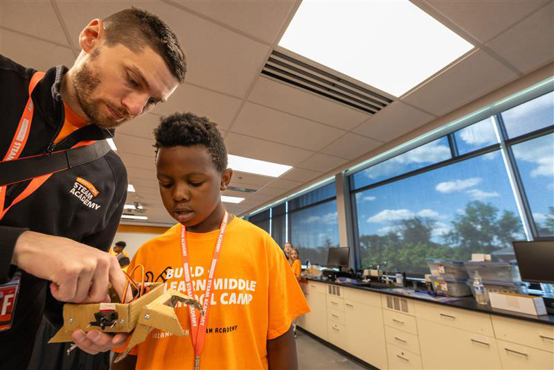 Caleb Hunter working with student