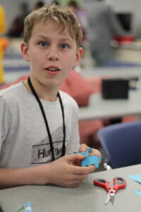 STEAM student folding a paper craft