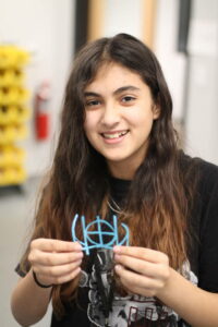 STEAM student holding a paper craft