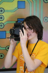 STEAM student using an antique camera