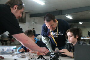 RWC students and instructors working on a robot