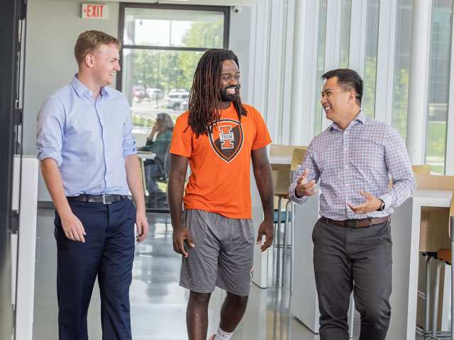 Lewis Roberts, Sam Bodley, and Dr. Thomas Tran walking in the Zollner Engineering Center