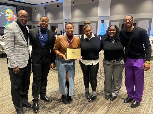 members of Indiana Tech's Black Excellence Association pose with their President's Award, given to them by the MLK Jr. Club